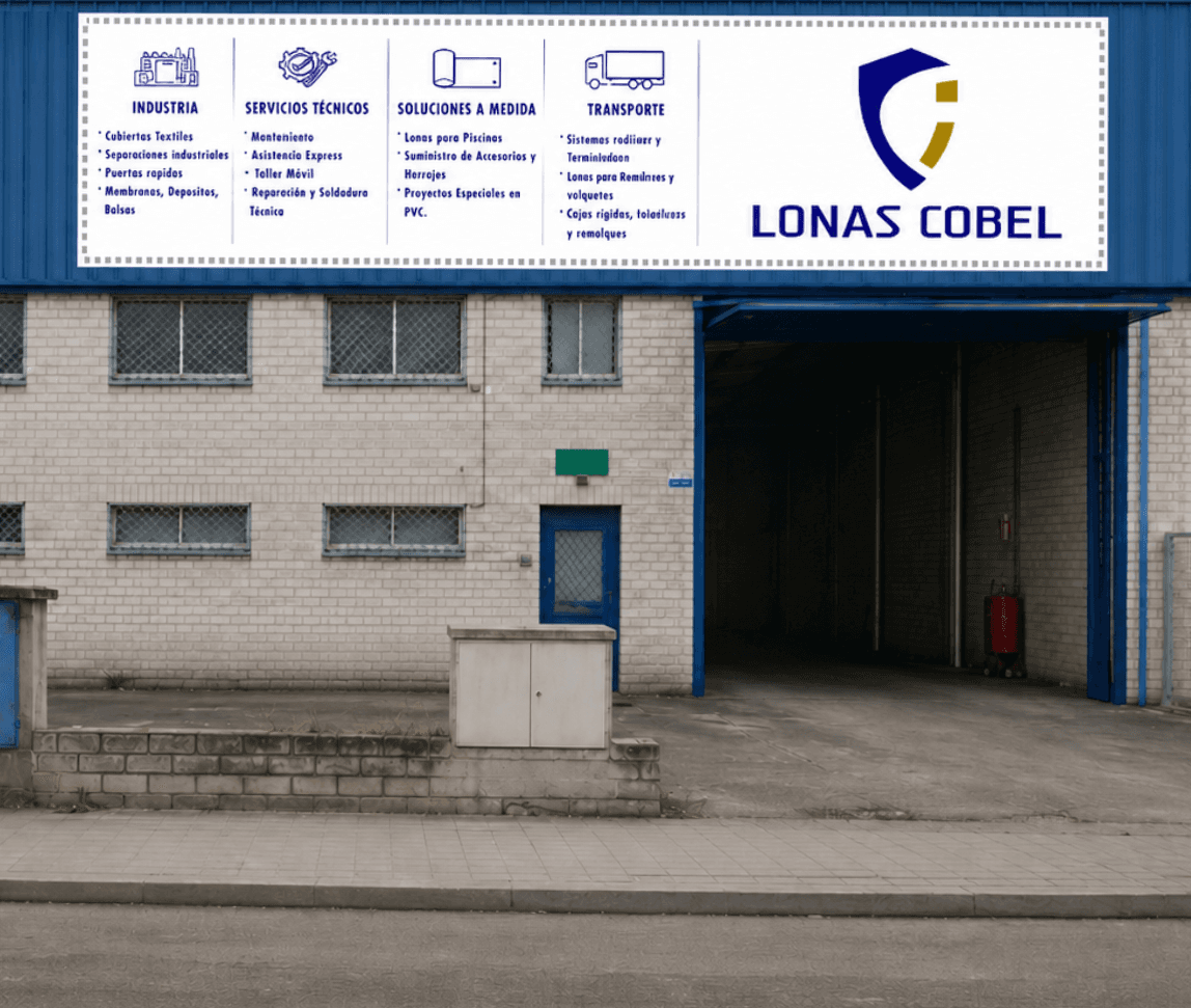 Fachada de la nave de Lonas Cobel en San Fernando de Henares, con acceso interior y rotulo de la empresa